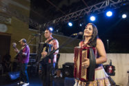 Man playing guitar, man and woman each playing accordions on stage in Fortaleza, Brazil