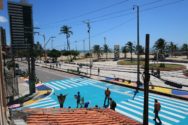 Intersection painted blue in front of beach boardwalk in Fortaleza, Brazil.