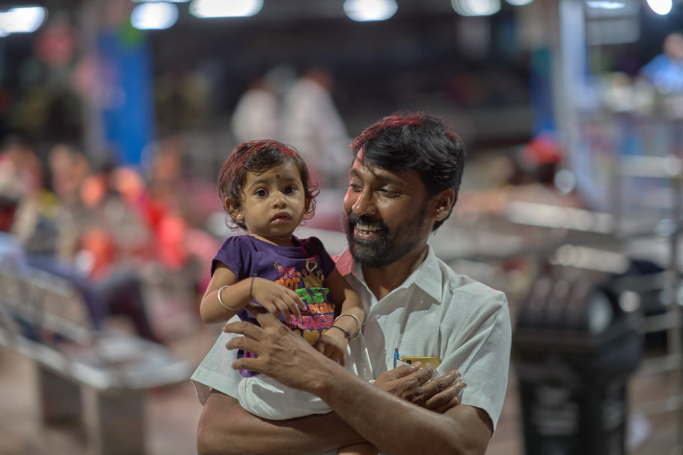 Man holds child in Pune, India
