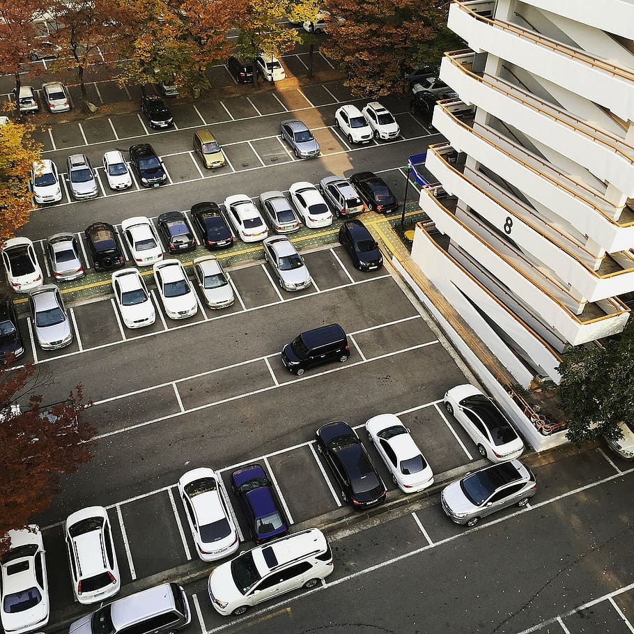 Large parking lot with many cars parked inside of it